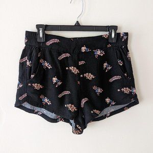 Express pull-on black dolphin shorts with pink and blue floral pattern
